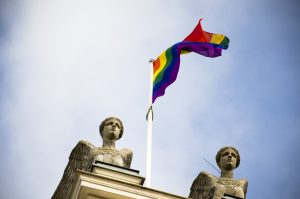 This image shows the rainbow flag hoisted over the university building